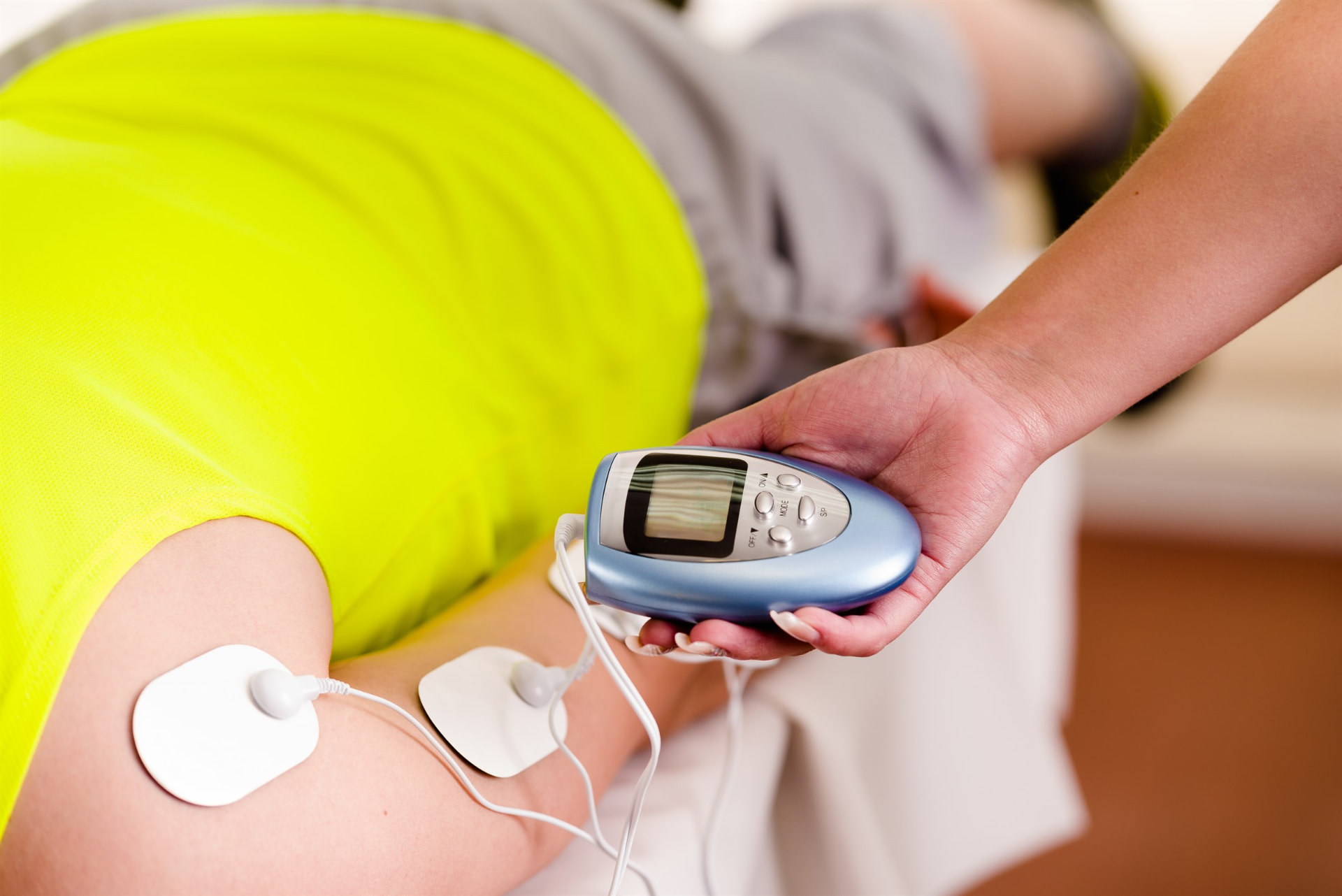 Electrical stimulation pads and handheld control used during a treatment session